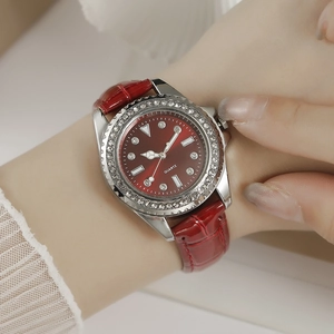 Close-up of luxury women quartz watch with red crocodile leather strap and diamond bezel