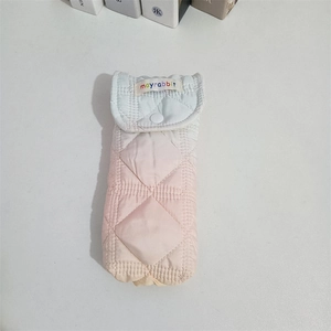 Close-up of quilted padded pouch with gradient colors and secure snap button closure