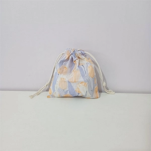 Detail of floral cotton drawstring bag with tulip print and white cord closure