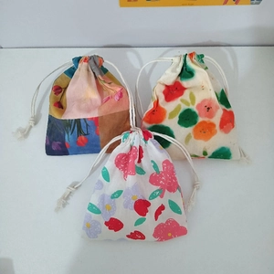 Three-piece set of cotton drawstring bags with artistic floral patterns for cosmetics