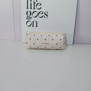 Detailed macro view of beige quilted heart pencil case with fabric May Rabbit label