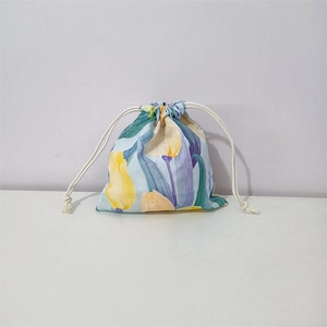 Detail of floral cotton drawstring pouch with blue base and tulip pattern