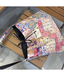 Close-up of ethnic patchwork tote bag with geometric prints and SEEYOU cloth label