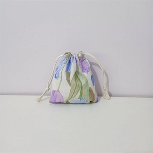 Close-up of floral drawstring pouch made of cotton with purple tulip prints