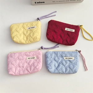 Quilted heart pattern mini cosmetic bags in four vibrant colors with zipper and wristlet