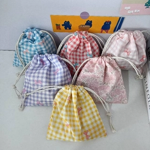 Detail of assorted floral and plaid cotton drawstring pouches for small items