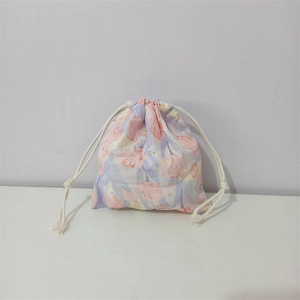 Detail of tulip printed cotton drawstring pouch showing soft fabric texture and cord