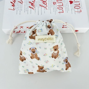 Detail of floral bear pattern cotton drawstring bag with mayrabbit woven label