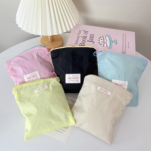 Mini macaron colored nylon cosmetic bags in pink blue and green with zipper closure