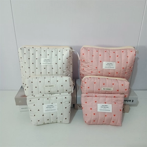 Quilted heart pattern makeup bag set in creamy white and pink with zip closure