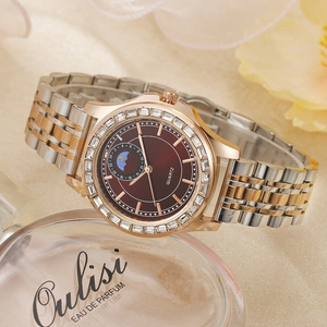 Detailed macro of a two-tone rose gold ladies quartz watch with a diamond-set bezel