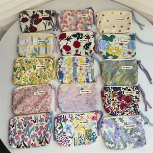 Assorted floral cotton makeup bags with zipper closure and braided ropes in various patterns
