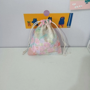 Close-up of small floral cotton drawstring pouch for jewelry and cosmetic storage