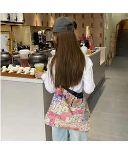 Ethnic patchwork denim shoulder bag with floral patterns and a side SEEYOU woven label