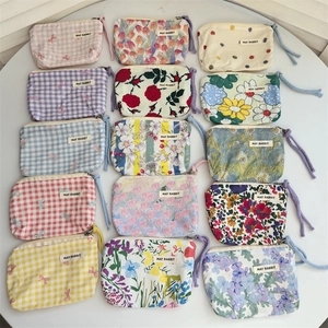 Variety of floral and plaid cotton coin purses with wrist straps and zipper closure