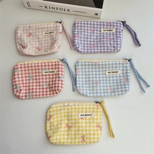 Set of five floral cotton cosmetic bags with zippers and bow prints in soft pastel colors