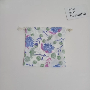 Detail of floral cotton drawstring storage bag with blue and green flower patterns
