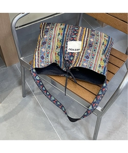 Detail of bohemian ethnic patterned canvas tote bag with black drawstring and SEEYOU label