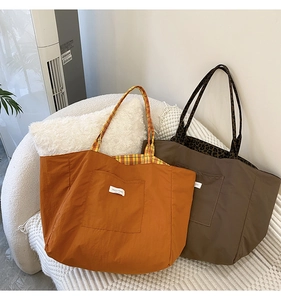 Detail of large tote bags in orange and brown with leopard and plaid patterned linings