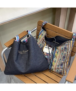Detail of ethnic patchwork tote bags with embroidery and colorful bohemian stripes