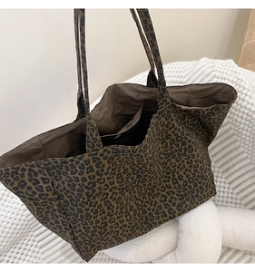 Macro shot of leopard print canvas tote bag interior with large capacity side pocket
