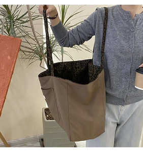 Detail of canvas tote bag with leopard print lining and practical exterior pocket
