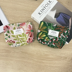 Floral embroidered storage bag for lipstick and makeup in pink and dark green