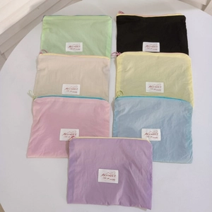 Set of seven macaron-colored nylon zipper storage bags in various pastel colors