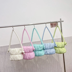 Padded cloud shoulder bags in macaroon colors with decorative knots on the straps