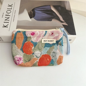 Detail of floral oil painting canvas coin purse with silver zipper and blue lanyard