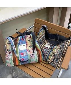Detailed close-up of ethnic style patchwork denim tote bags with floral and geometric patterns