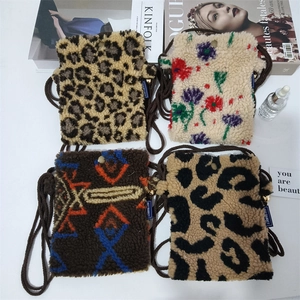 Flat lay of mini plush crossbody bags in leopard and floral patterns with magazines