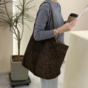 Vintage leopard print canvas tote bag for women showing spacious interior on a shoulder
