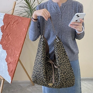 Fashionable leopard print canvas tote bag with drawstring bow and handmade metal plate