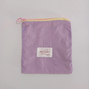 Detail of lavender nylon pouch with contrast zipper and Mayrabbit embroidered label