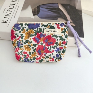 Detailed view of floral cotton pouch with purple drawstring and May Rabbit textile label
