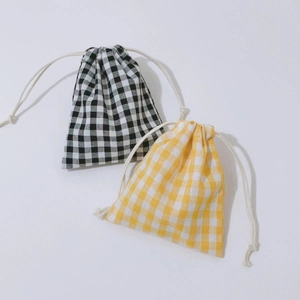 Close-up of black and yellow gingham drawstring storage bags with cotton rope details