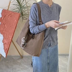 Brown canvas tote bag with beau merci print and leopard print detail on a model