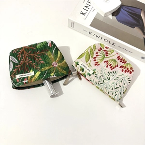Detailed close-up of quilted floral cosmetic bags with vintage botanical patterns