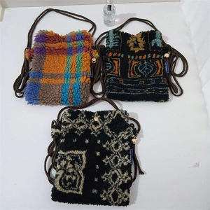Three plush mini crossbody bags in checkered and geometric patterns with rope straps