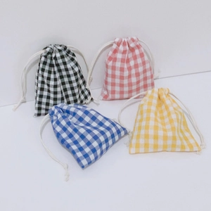 Detail of colorful plaid drawstring pouches in blue pink yellow and black checkered fabric