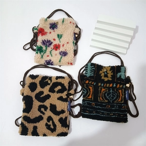 Mini plush crossbody phone bags in floral, leopard, and ethnic patterns with slim straps