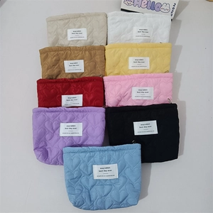 Set of quilted heart cosmetic pouches in nine colors including pink and beige