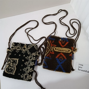 Close-up of plush lamb wool mini crossbody bags with pattern and woven strap