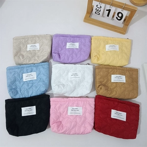 Detailed grid showing nine colorful quilted heart mini cosmetic pouches with zip closure