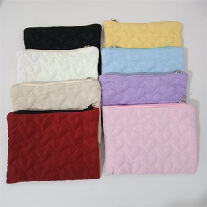 Detailed grid showing quilted heart-pattern mini pouches in various candy colors with zippers
