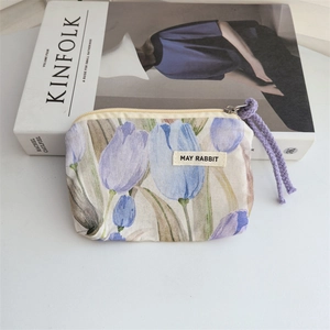 Detail of floral cotton coin purse with blue tulips and woven zipper pull cord