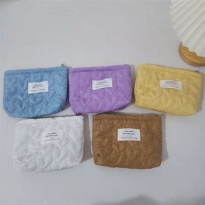 Quilted heart pattern cosmetic bags in five pastel colors with cute woven label tags