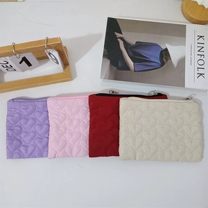 Quilted heart pattern mini storage bags in purple, pink, red, and beige with zippers