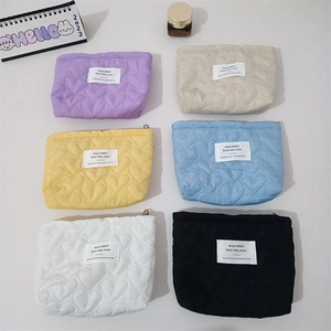 Quilted heart pattern cosmetic bags in six colors with a minimalist rectangular label